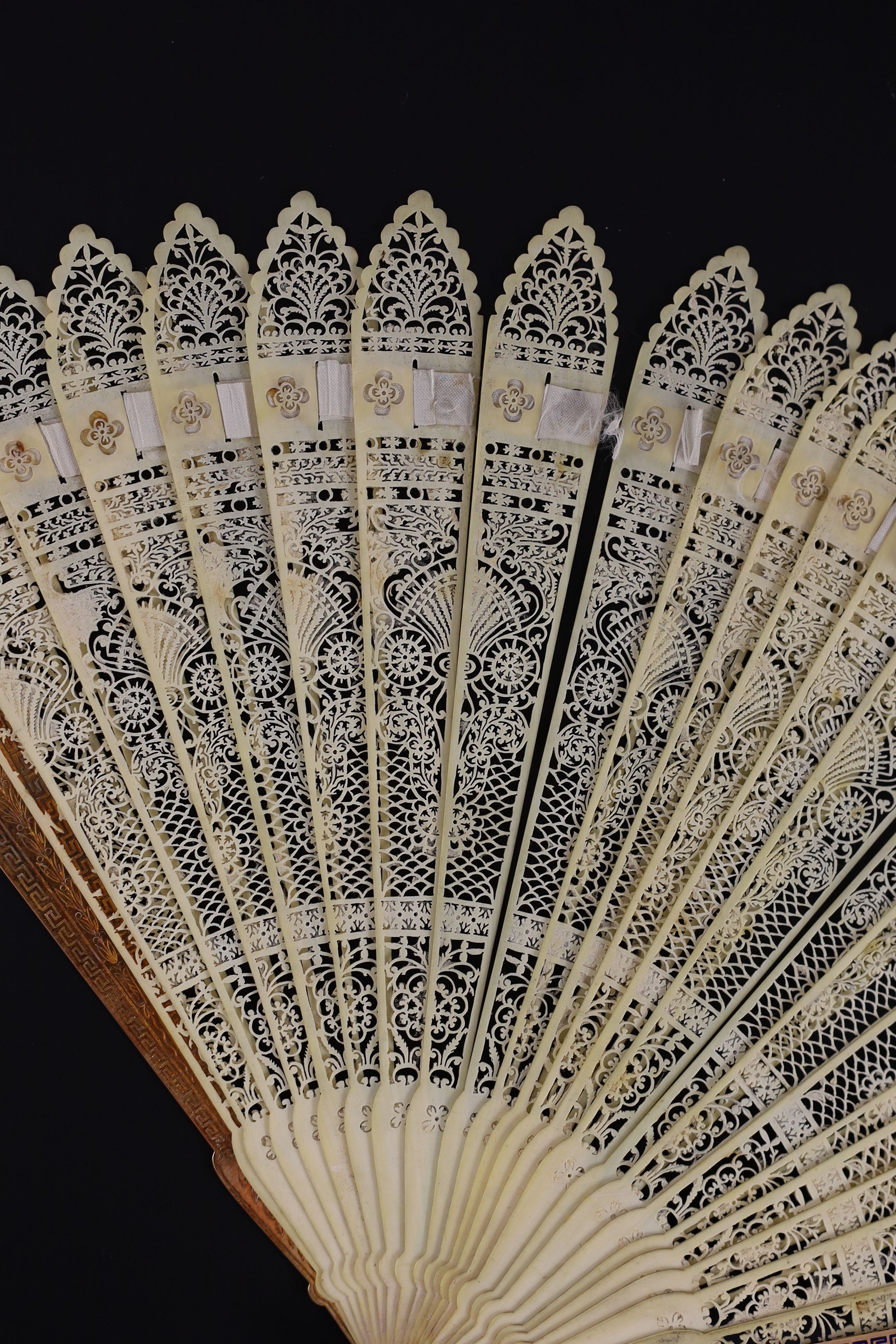 A German or Swiss gold, enamel and ivory brise fan, 19th century, possibly made for the Ottoman market, 17.3 cm closed, slight losses to sticks, needs rethreading